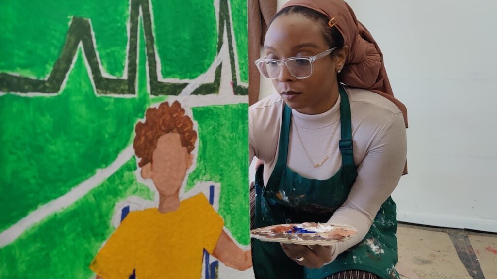 Aaminah Rasheed paints sculpture for display