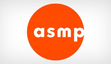 The image shows the lowercase white letters "asmp" centered inside a large, solid orange circle on a light gray background.