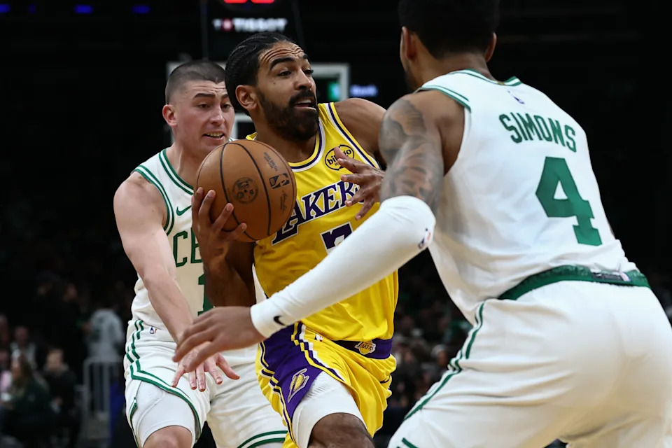 Dec 5, 2025; Boston, Massachusetts, USA; Los Angeles Lakers guard Gabe Vincent (7) tries to drive between Boston Celtics guard Anfernee Simons (4) and guard Payton Pritchard (11) during the first half at TD Garden. Mandatory Credit: Winslow Townson-Imagn Images