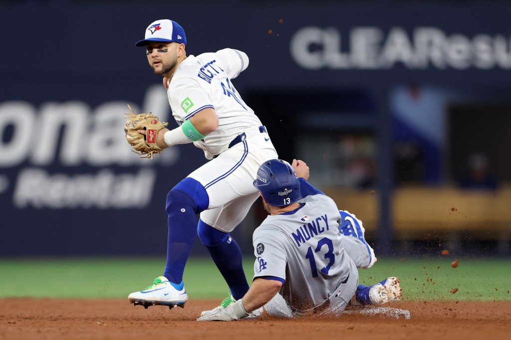 Bo Bichette of the Toronto Blue Jays forces Max Muncy of the Los Angeles Dodgers out during the sixth inning of the 2025 World Series.