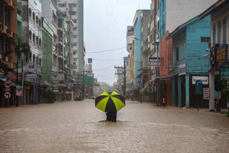 A person wades through a flooded area in Hat Yai district of Songkhla in southern Thailand on Nov 22, 2025. (Photo: Reuters)