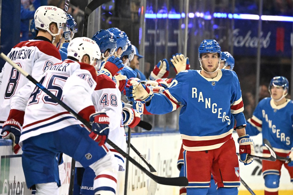 Rangers left wing Will Cuylle (50) celebrates with his teammates on the bench.