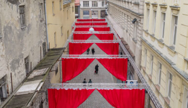 red and white curtains transform czech historic center into christmas installation