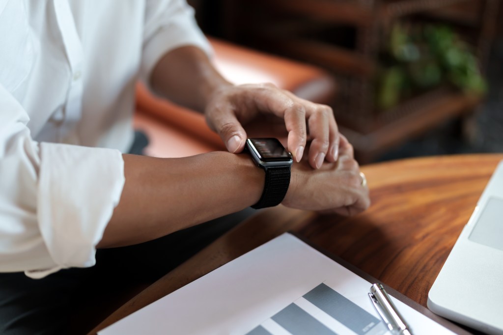 Close-up of a person checking a smartwatch.