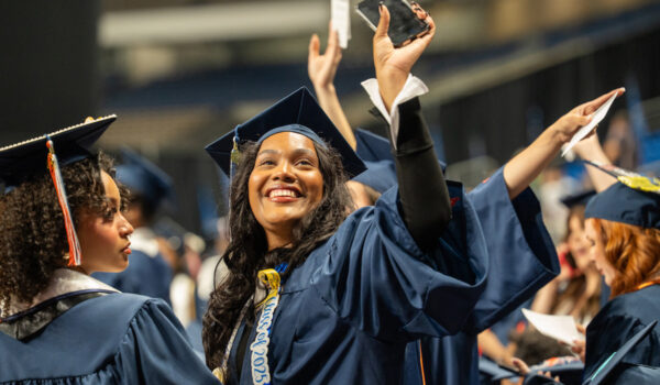 graduating student waving
