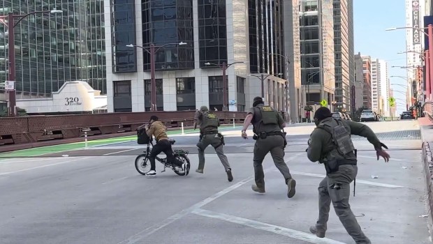 In an image from video posted on the social platform X, U.S. Border Patrol agents chase a bicyclist who had a verbal altercation with the agents as they patrolled locations in Chicago on Sunday, Sept. 29, 2025 (Christopher Sweat)