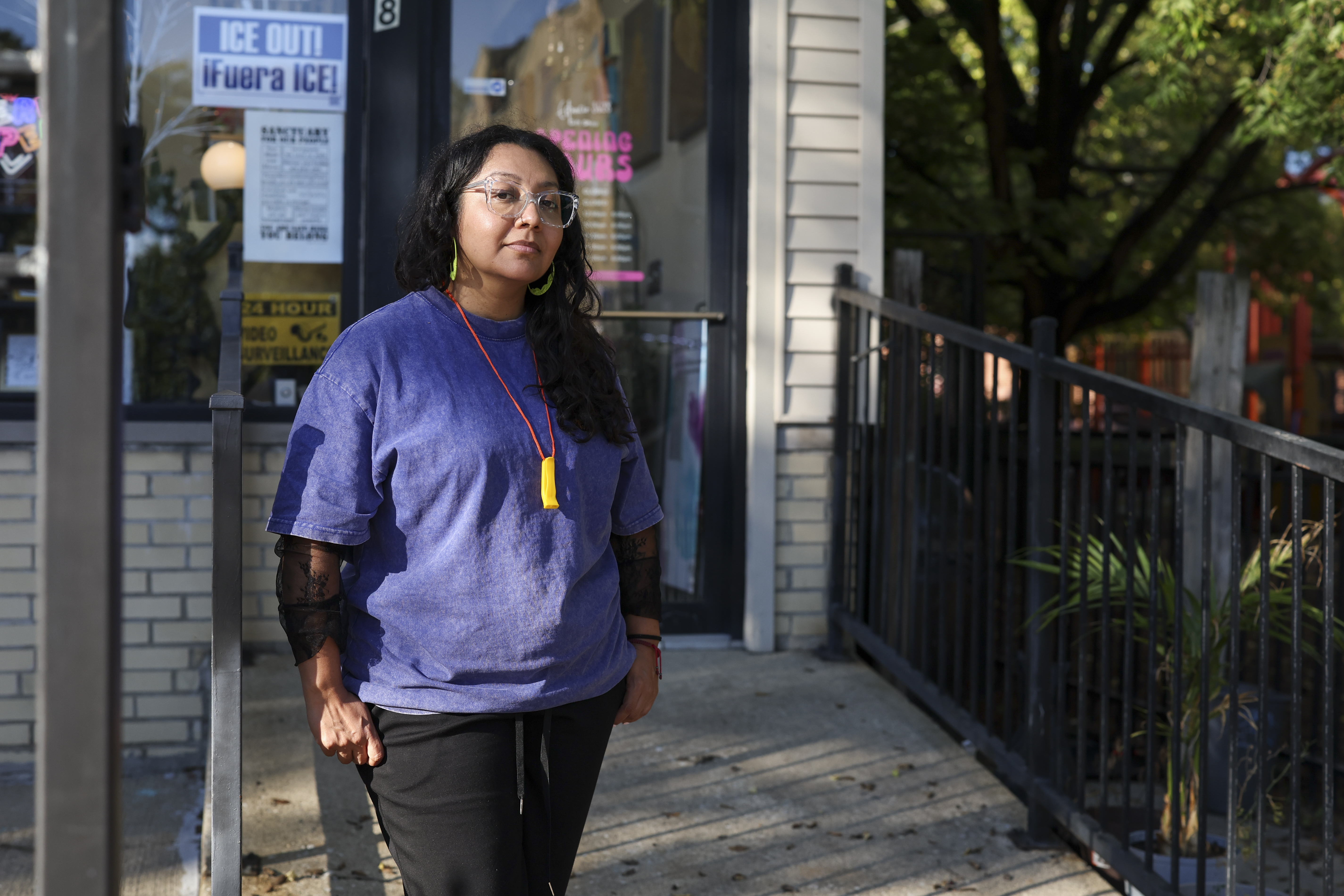 Evelyn Medina stands outside her business, Espacio 3628, passing out...