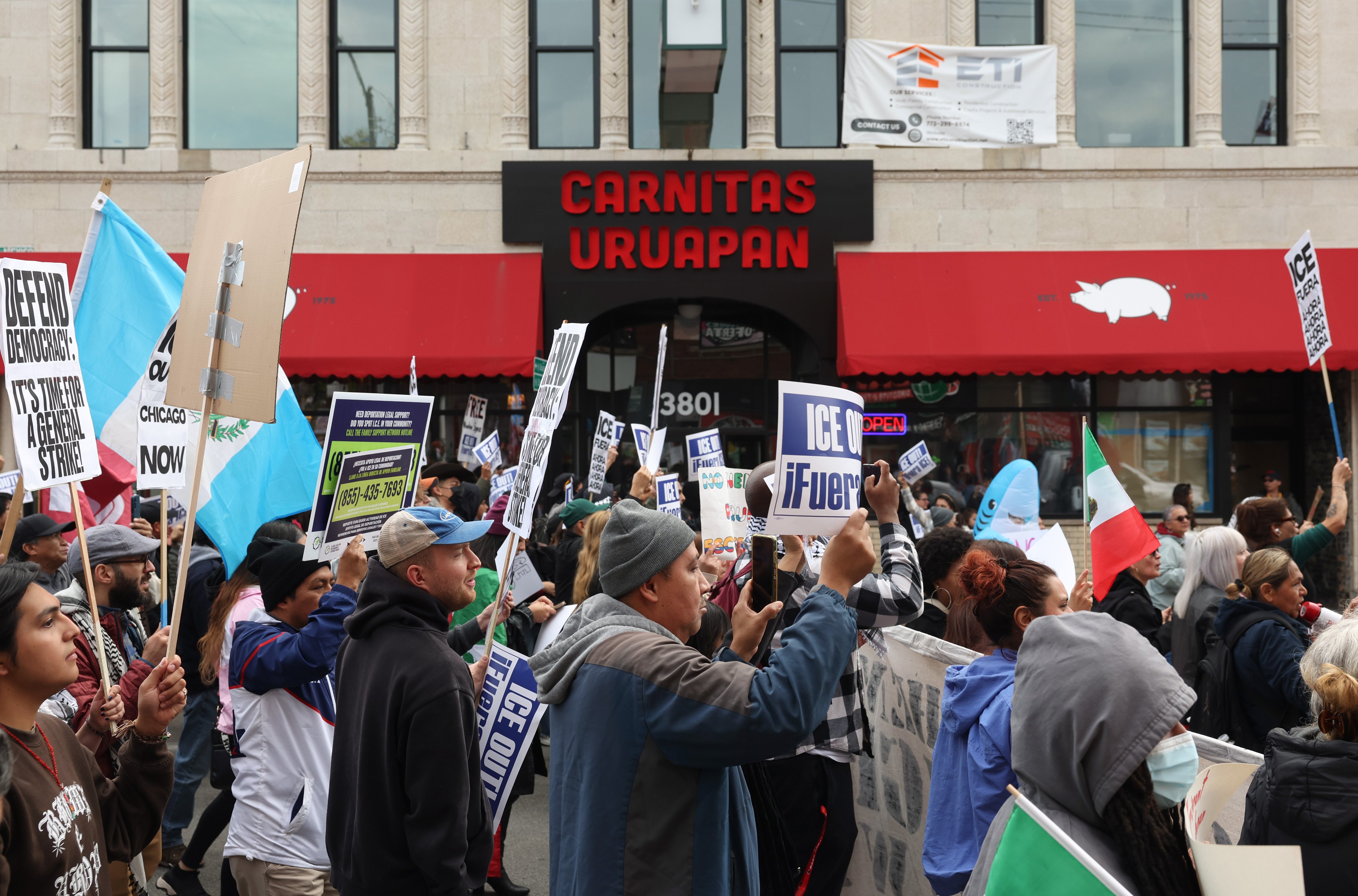Demonstrators march past Carnitas Uruapan, 3801 W. 26th St., in the Little Village neighborhood to protest Immigration and Customs Enforcement actions, Oct. 25, 2025, in Chicago. (John J. Kim/Chicago Tribune)