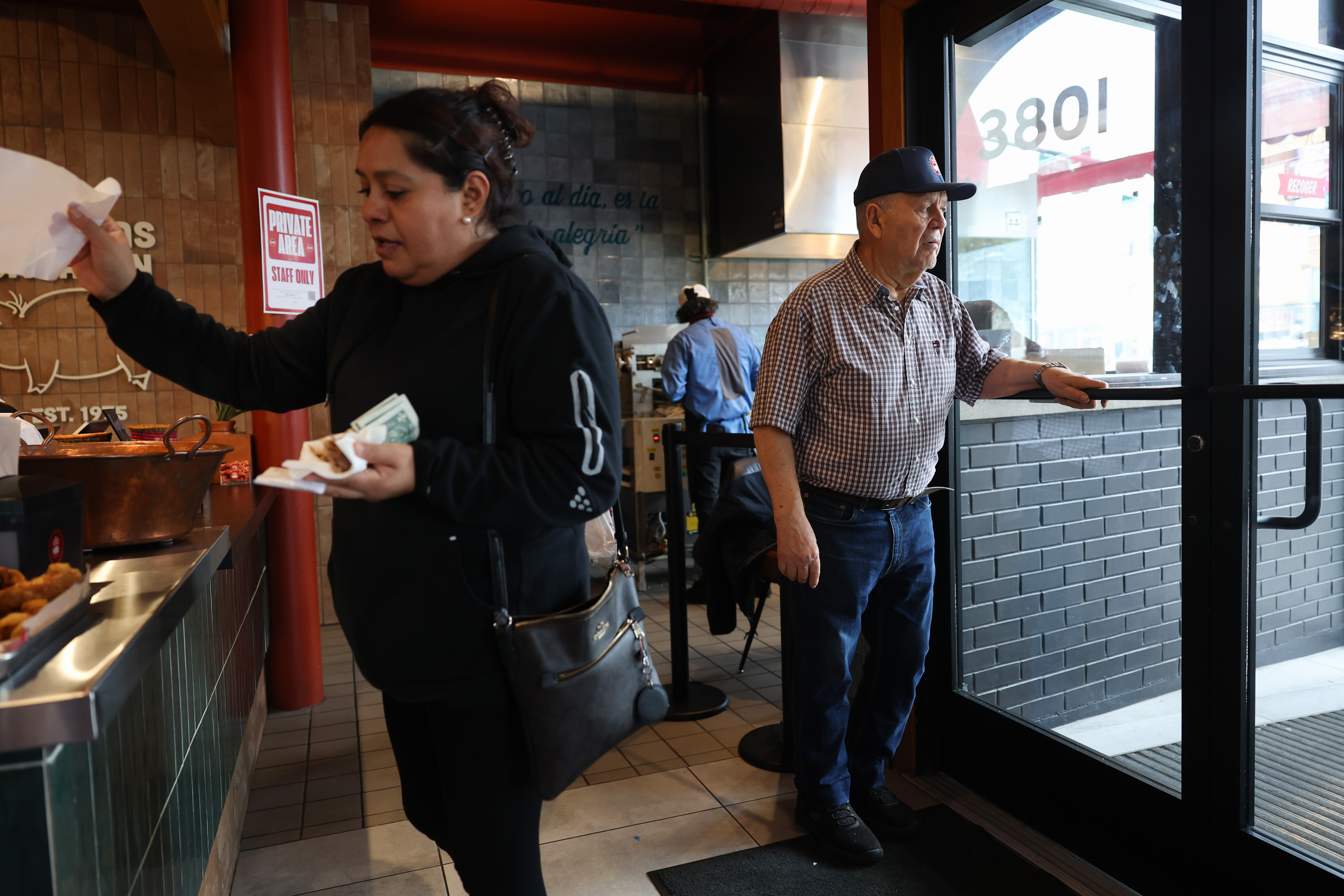 Inocencio Carbajal monitors the entrance to Carnitas Uruapan in Chicago's...