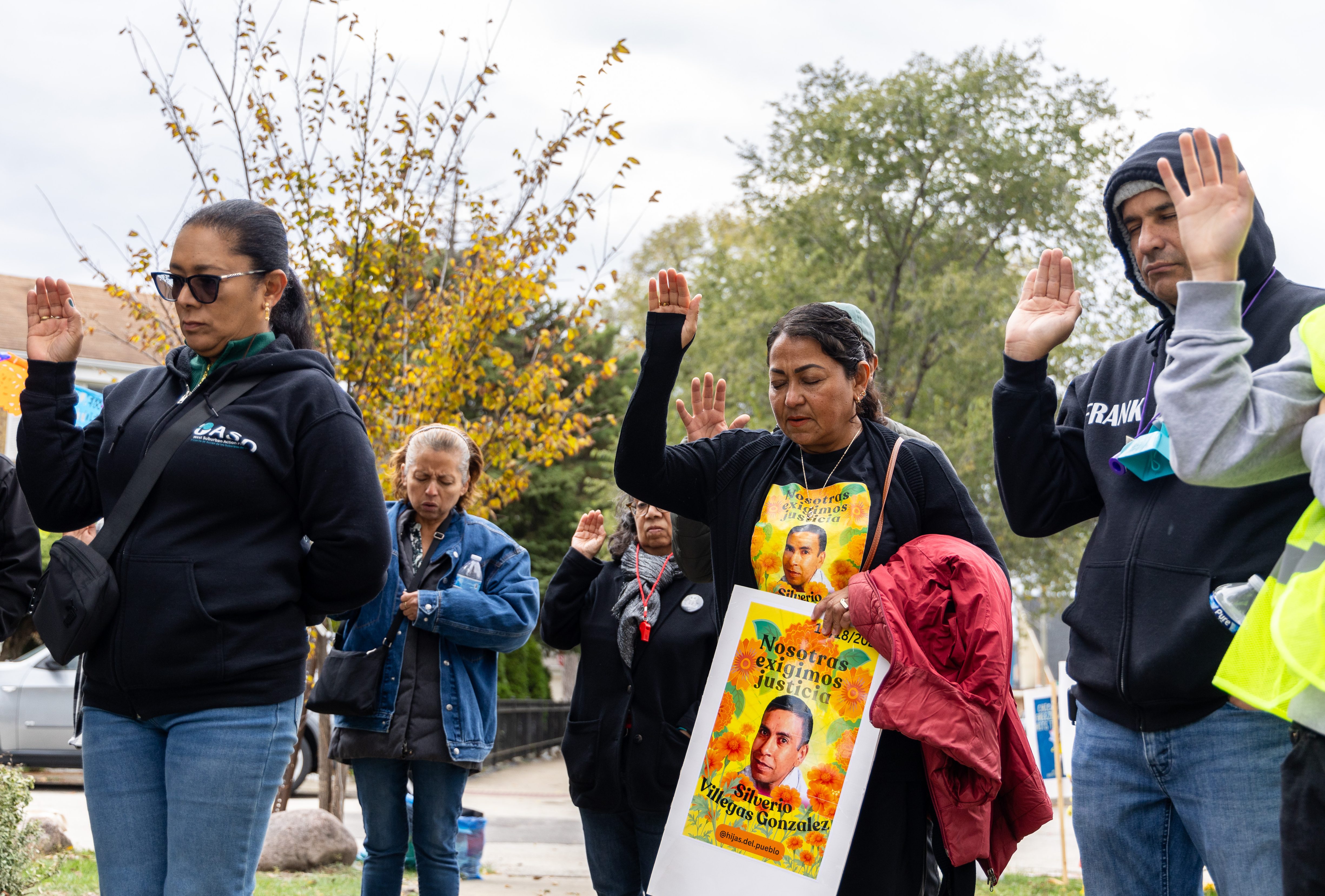 Mourners pray while the Rev. Roberto Moreno, pastor at Franklin...