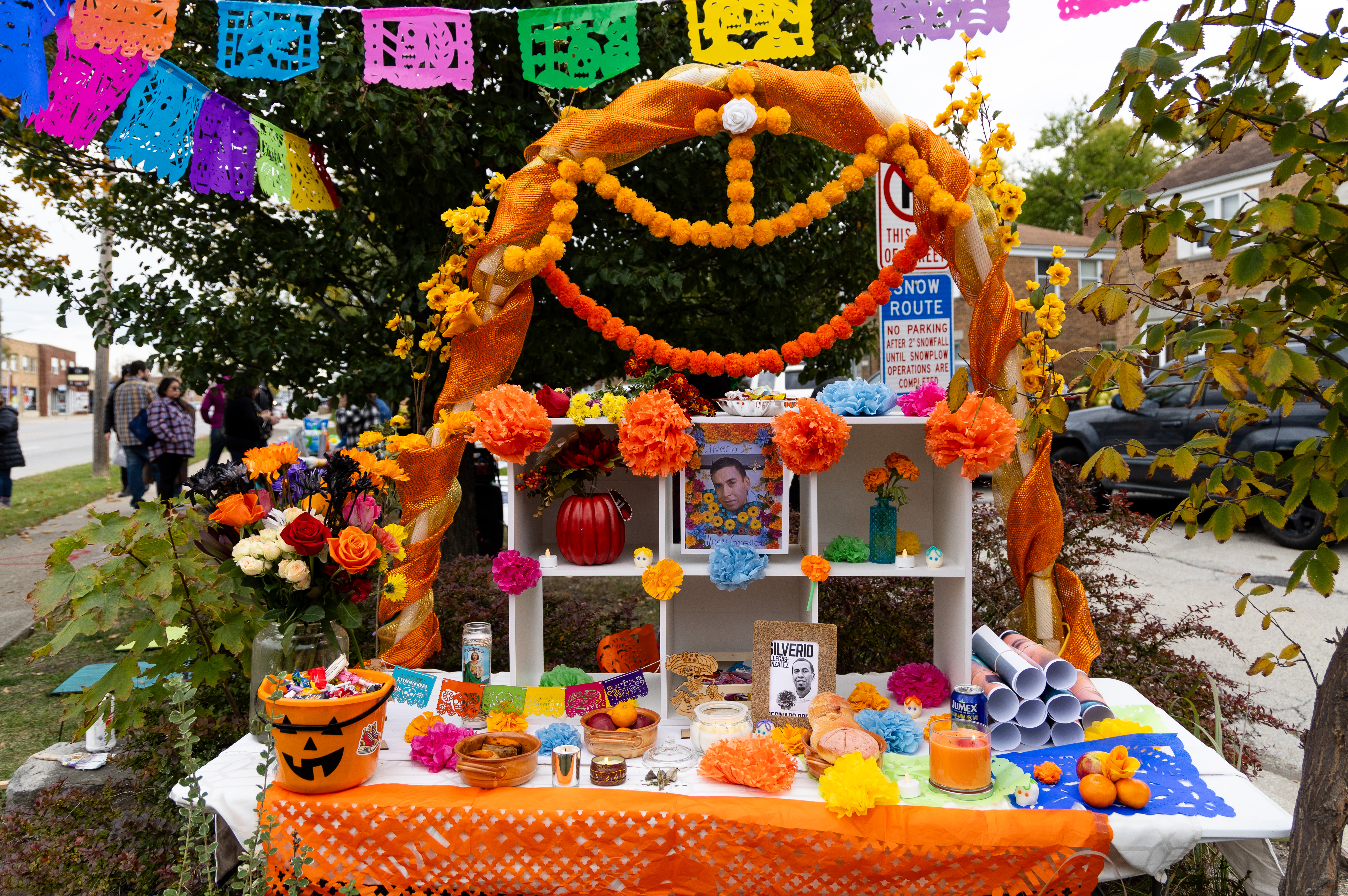 Attendees placed various objects, like candles, sugar skulls and flowers...