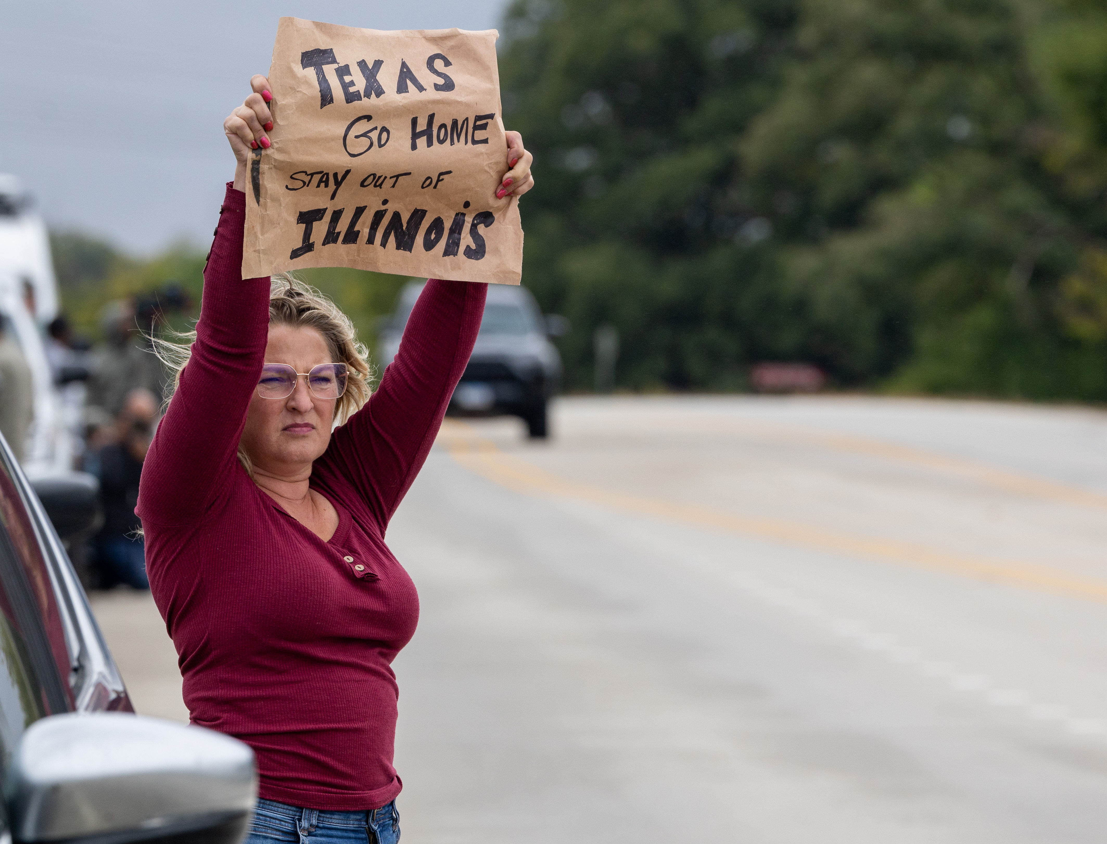 Erin Gallagher, of Will County, protests the arrival of members...