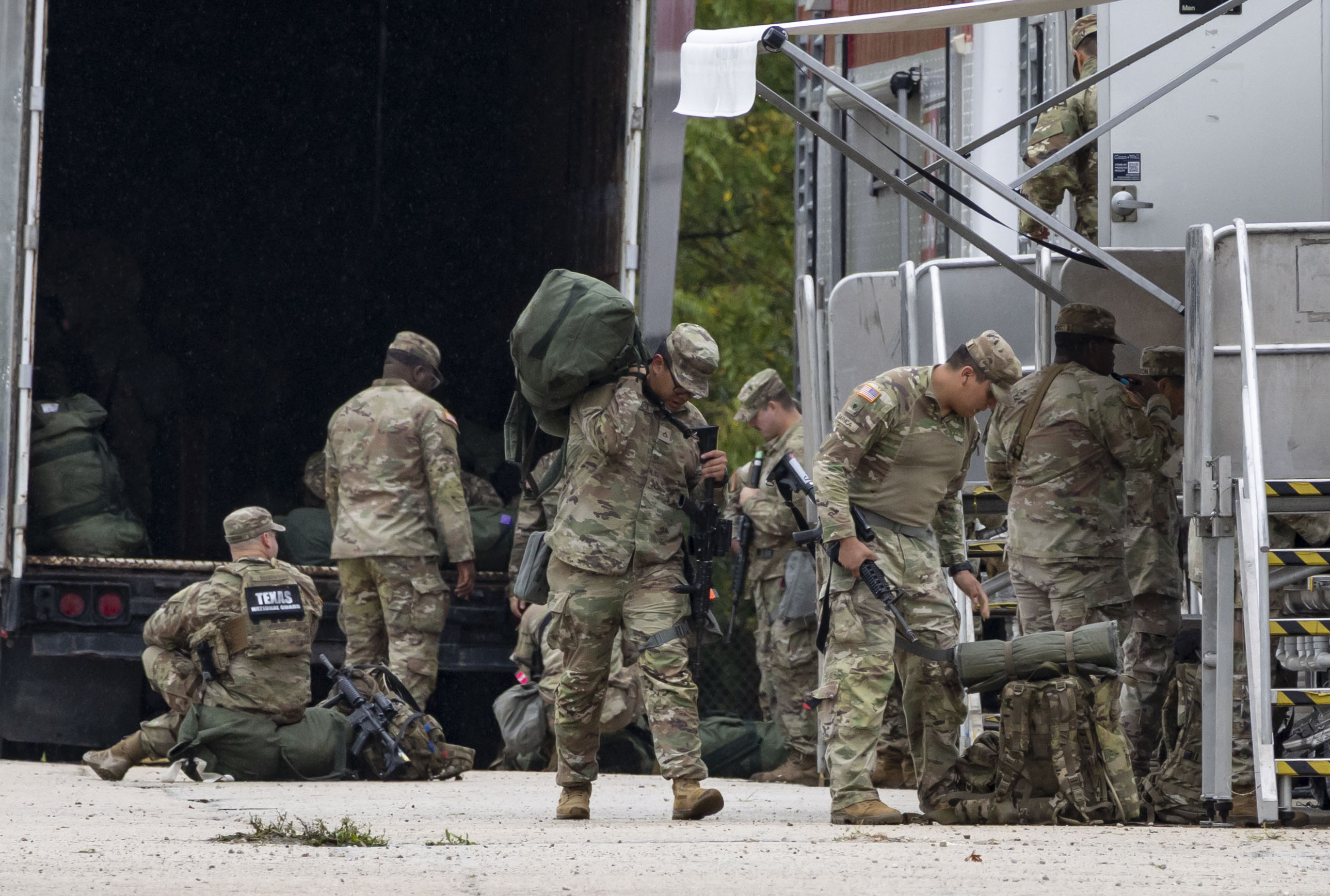 Members of the Texas National Guard arrive Oct. 7, 2025,...