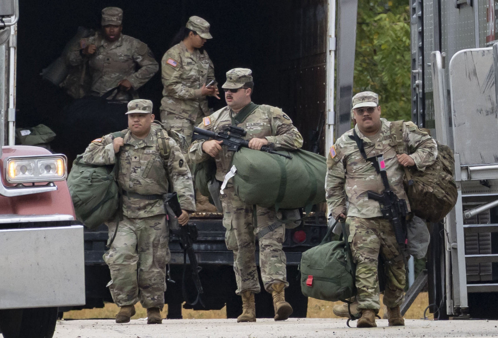Texas National Guard members arrive on Oct. 7, 2025, at...