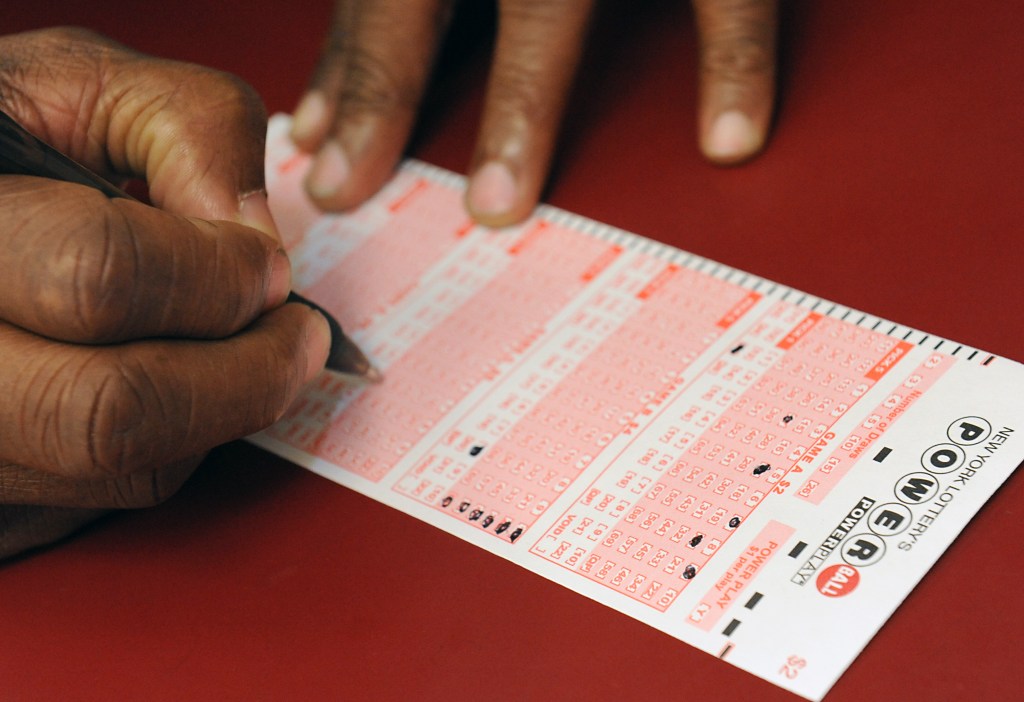 Customer Jay White filling out a Powerball form.