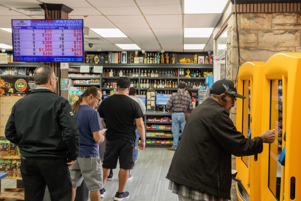 Customers wait in line to purchase lottery tickets at Bluebird Liquor in Hawthorne, Calif., on Dec. 1, 2025.