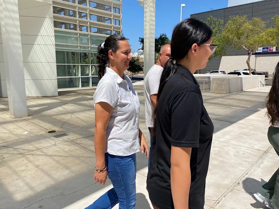 Flor Ivet Vargas-Loya, wife of El Taco Loko owner Blademir Angulo Audeves, in white, leaves U.S. District Court in Phoenix on Aug. 20, 2025, following her husband pleading guilty to habitual employment of people in the country illegally.