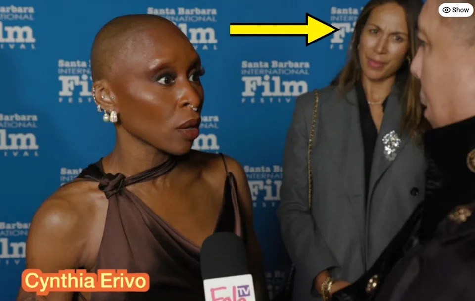 Cynthia looking shocked in an interview, with Meredith standing behind her and appearing uncomfortable