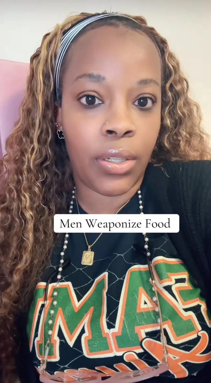 Person wearing a graphic T-shirt and headband seen in a selfie with overlaid text: "Men Weaponize Food."