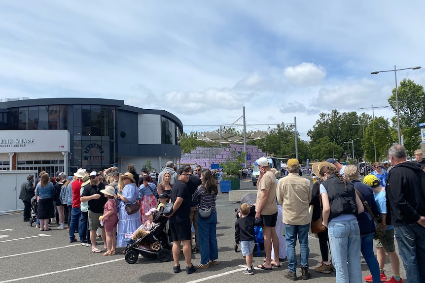 People waiting in a line near a Hobart festival.