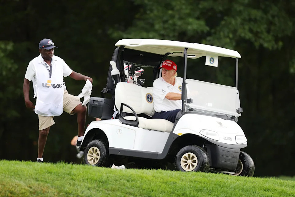 President Donald Trump typically goes golfing in a white collared shirt and a MAGA hat. / Mike Stobe / Getty Images