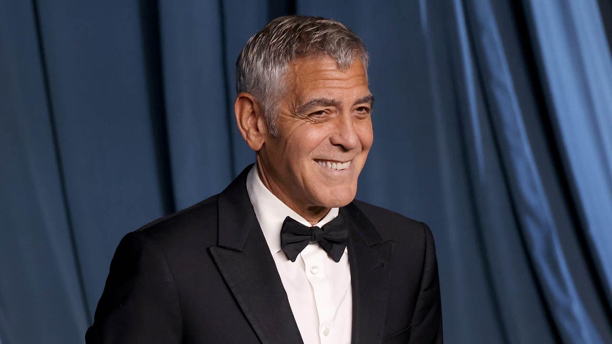 George Clooney smiles on stage 