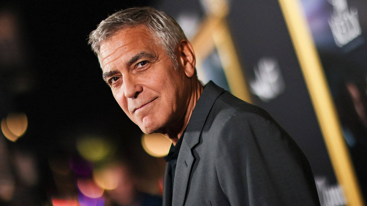 George Clooney wears grey suit on red carpet
