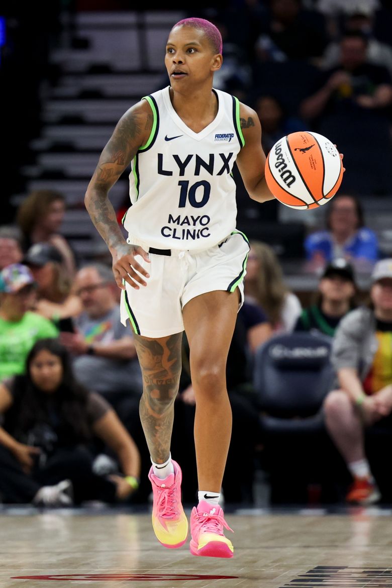 Courtney Williams of the Minnesota Lynx during a game against the Connecticut Sun, wearing her bright pink and yellow Moolah Kicks.