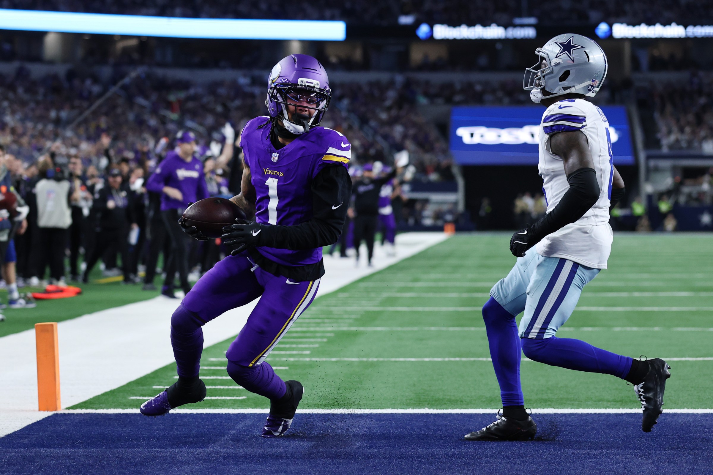 ARLINGTON, TEXAS - DECEMBER 14: Jalen Nailor #1 of the Minnesota Vikings scores a receiving touchdown against Donovan Wilson #6 of the Dallas Cowboys during the fourth quarter at AT&T Stadium on December 14, 2025 in Arlington, Texas. (Photo by Stacy Revere/Getty Images)