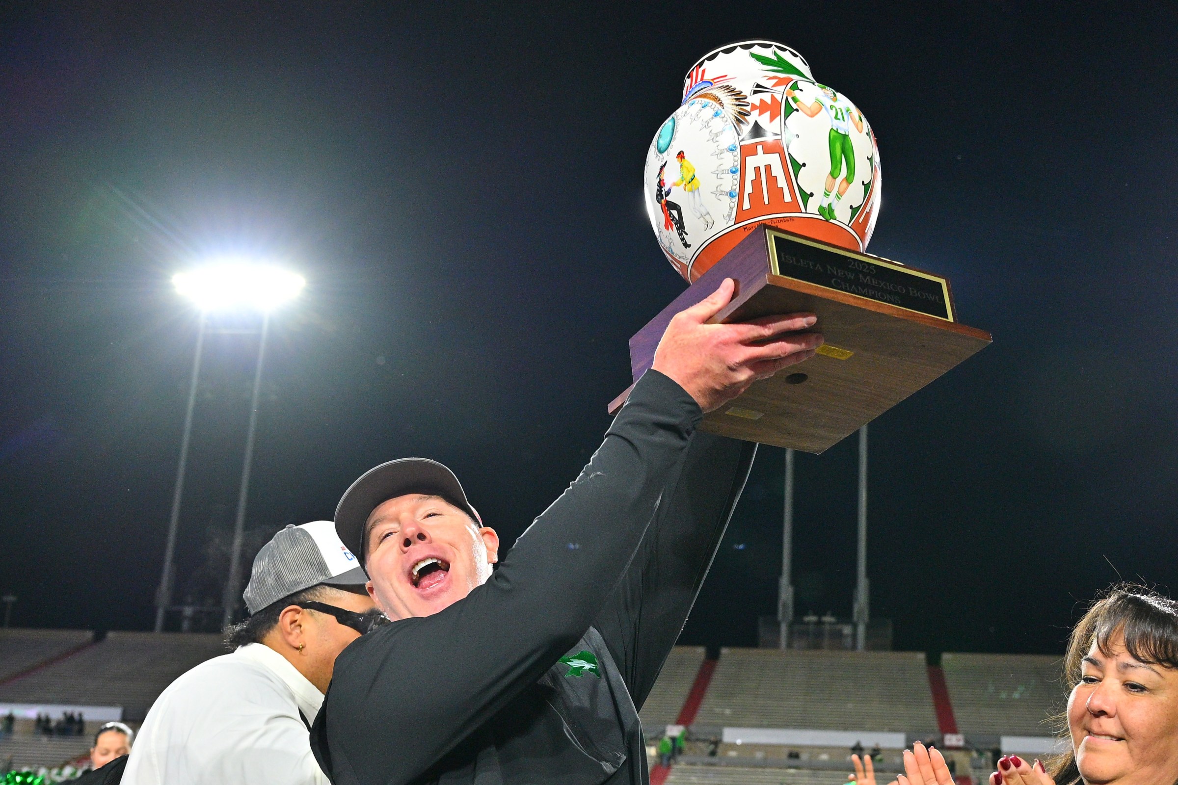 ALBUQUERQUE, NEW MEXICO - DECEMBER 27: Interim head coach Drew Svoboda of the North Texas Mean Green raises the championship trophy after his team defeated the San Diego State Aztecs 49-47 in the Isleta New Mexico Bowl at University Stadium on December 27, 2025 in Albuquerque, New Mexico. (Photo by Sam Wasson/Getty Images)