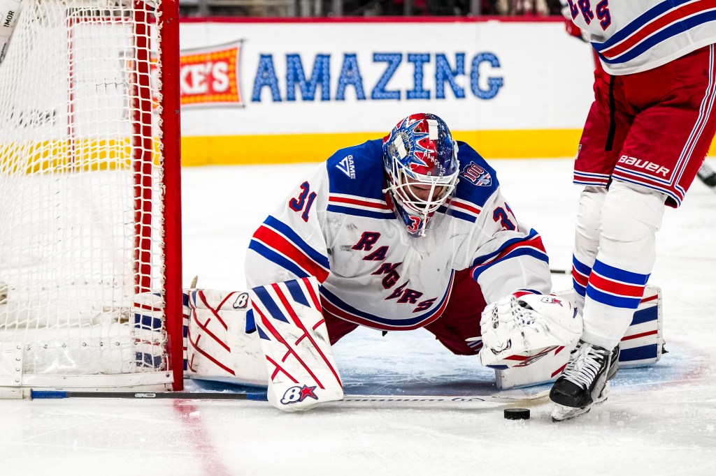 New York Rangers goaltender Igor Shesterkin defending the net.