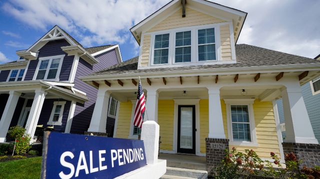 A home is seen with a 'for sale' sign. (File/Spectrum News) (AP File Photo/Michael Conroy)