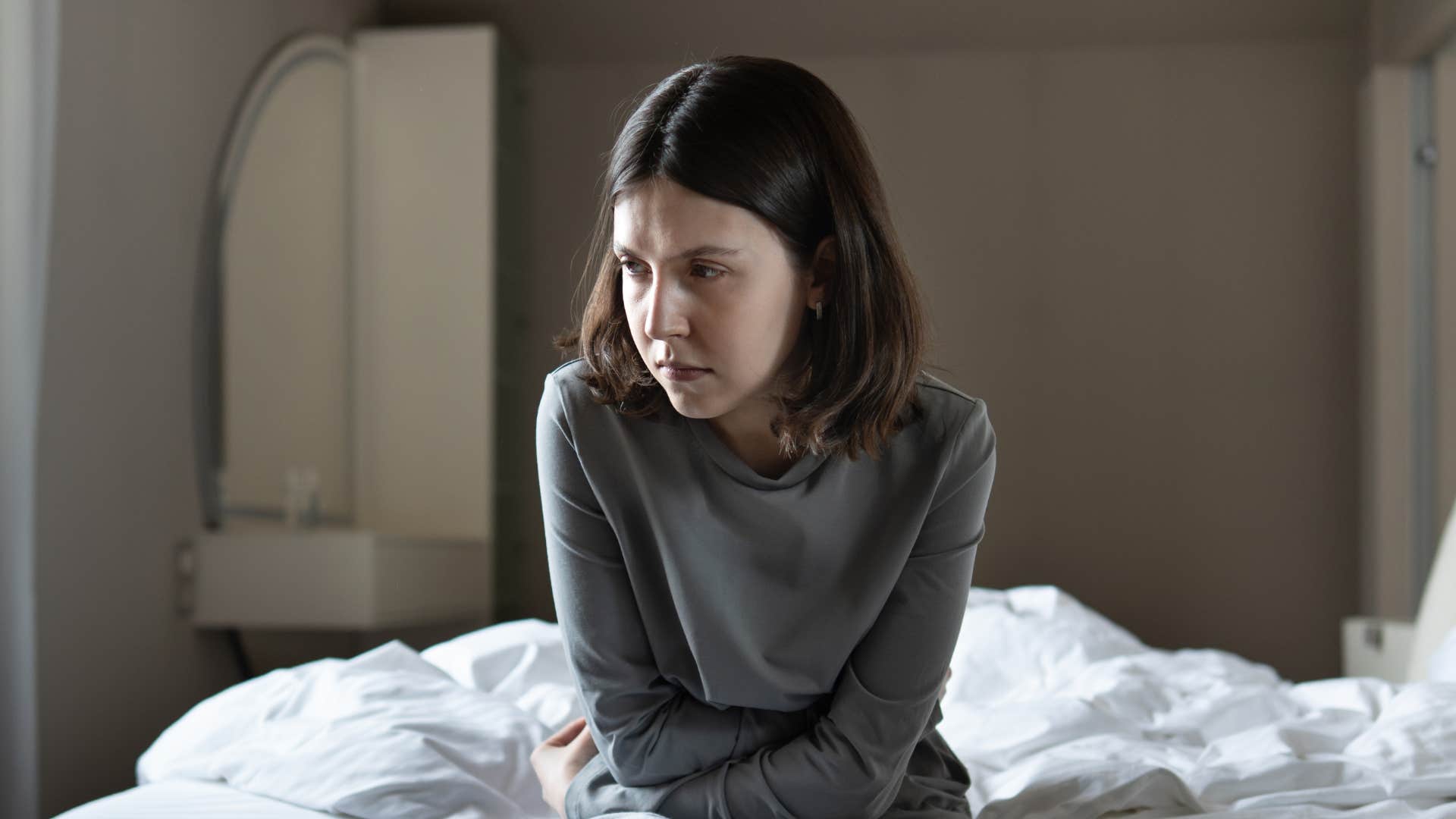 woman sitting up in bed feeling stressed
