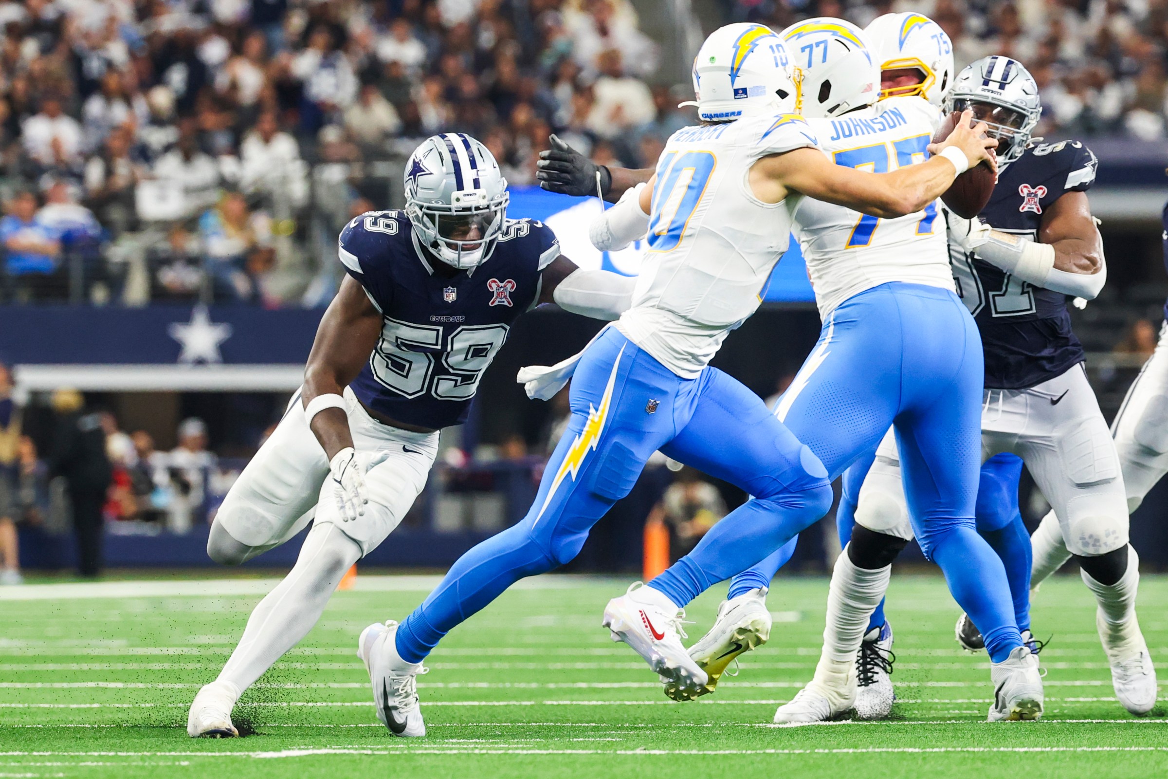 Dec 21, 2025; Arlington, Texas, USA; Dallas Cowboys linebacker Kenneth Murray Jr. (59) pursues Los Angeles Chargers quarterback Justin Herbert (10) during the fourth quarter at AT&T Stadium. Mandatory Credit: Kevin Jairaj-Imagn Images