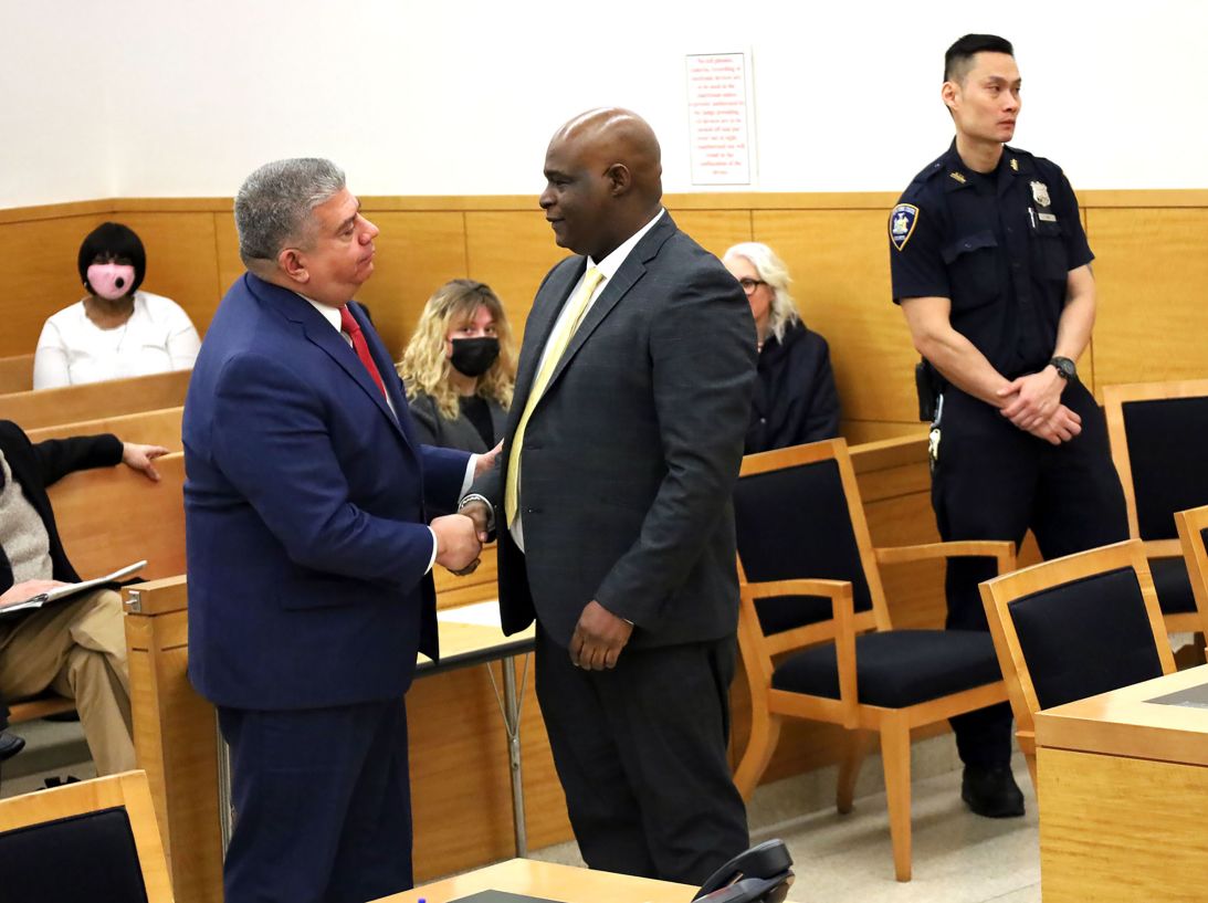 Brooklyn District Attorney Eric Gonzalez shakes hands with McDowell following a 2023 hearing vacating McDowell's sentence.