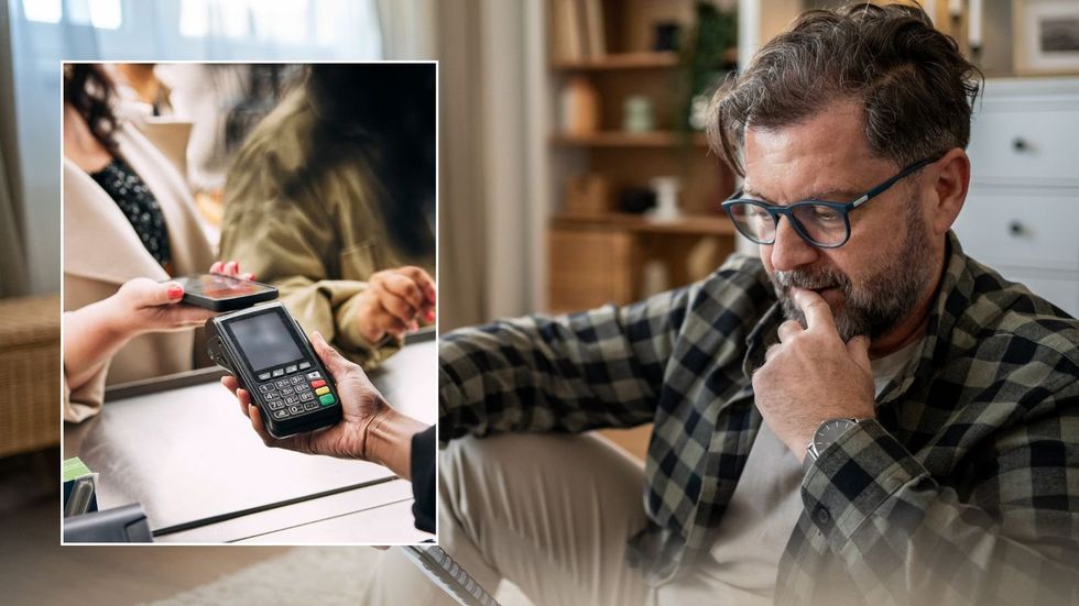 Man looking at bill and contactless payment