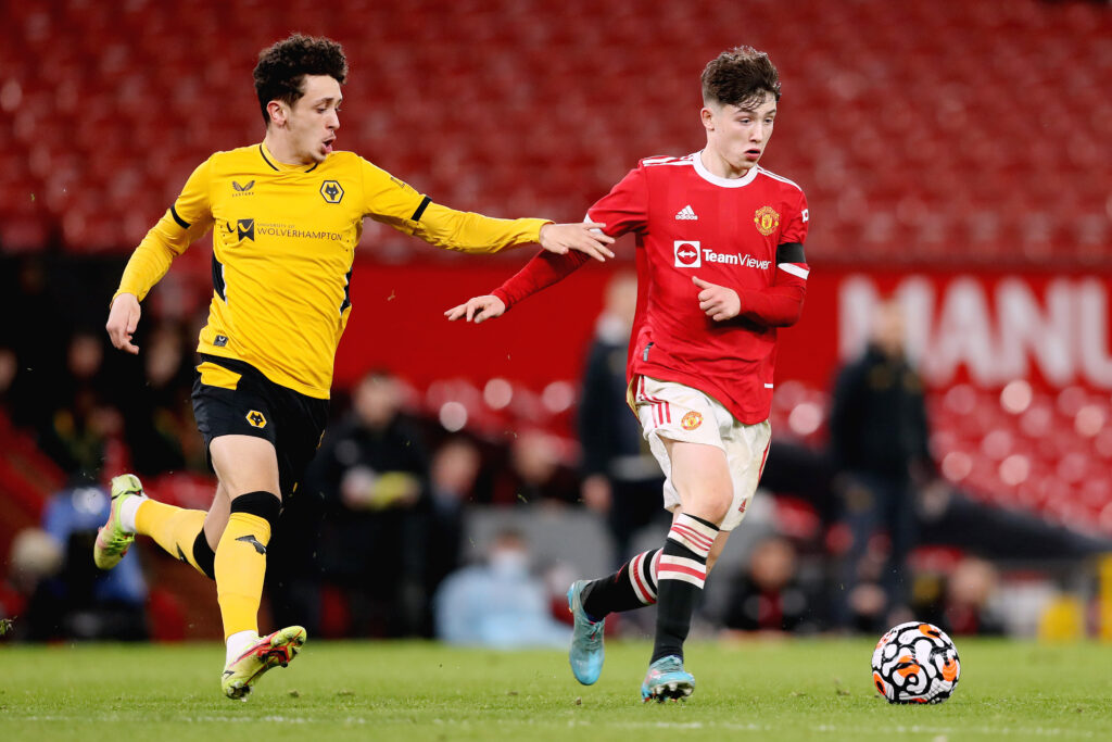 MANCHESTER, ENGLAND - MARCH 09: Dan Gore of Manchester United holds off Josh Esen of Wolverhampton Wanderers during the FA Youth Cup Semi Final match between Manchester United and Wolverhampton Wanderers at Old Trafford on March 09, 2022 in Manchester, England. (Photo by Charlotte Tattersall/Getty Images)