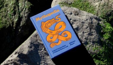 book with cover saving up sitting on a moss-covered rock outside