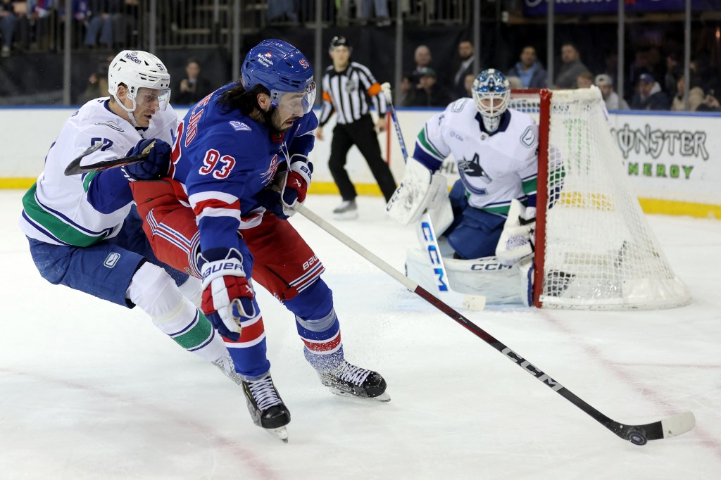 New York Rangers center Mika Zibanejad (93) plays the puck against Vancouver Canucks defenseman Tyler Myers (57) during the second period.
