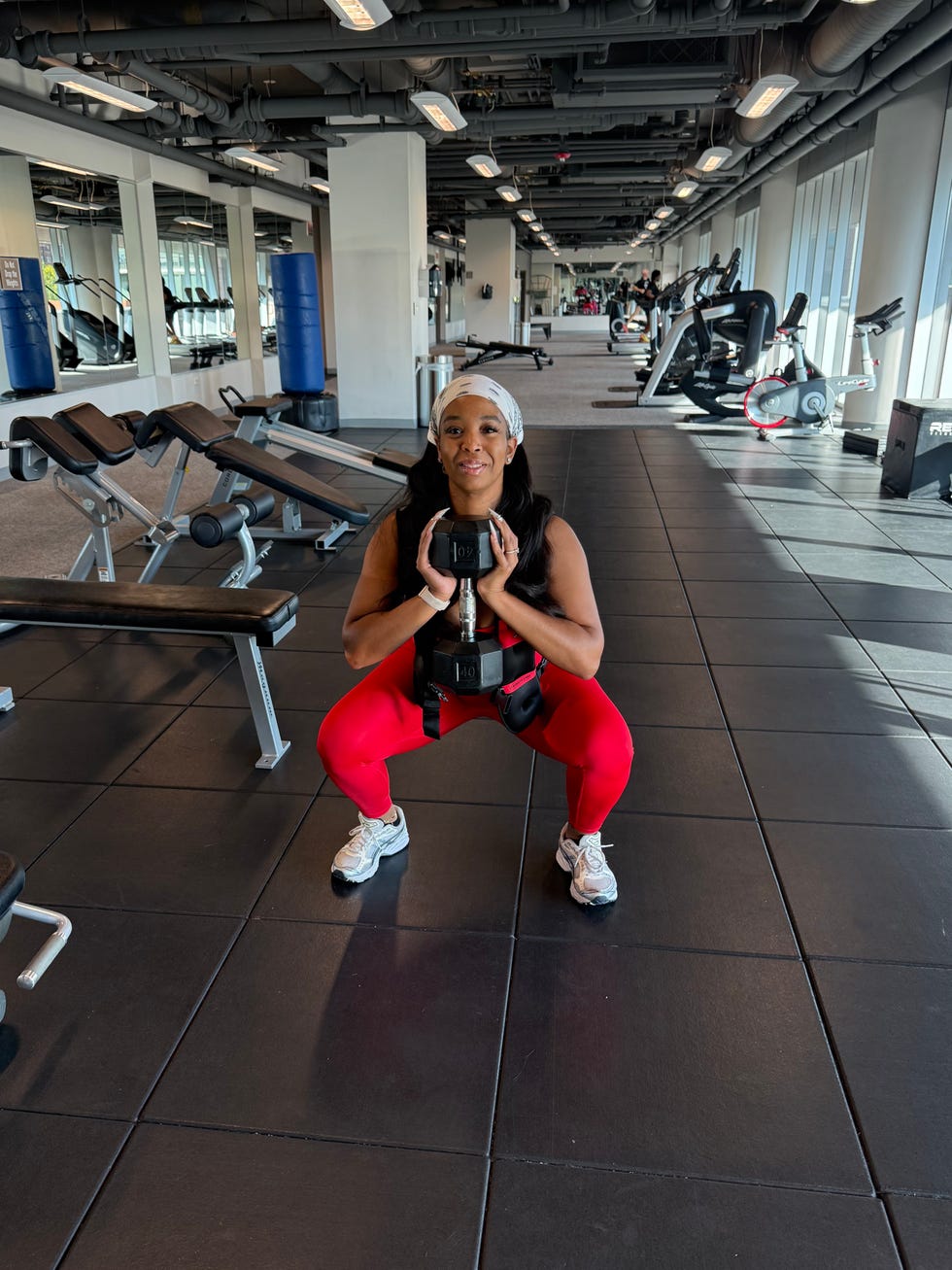 individual performing a squat exercise in a gym setting