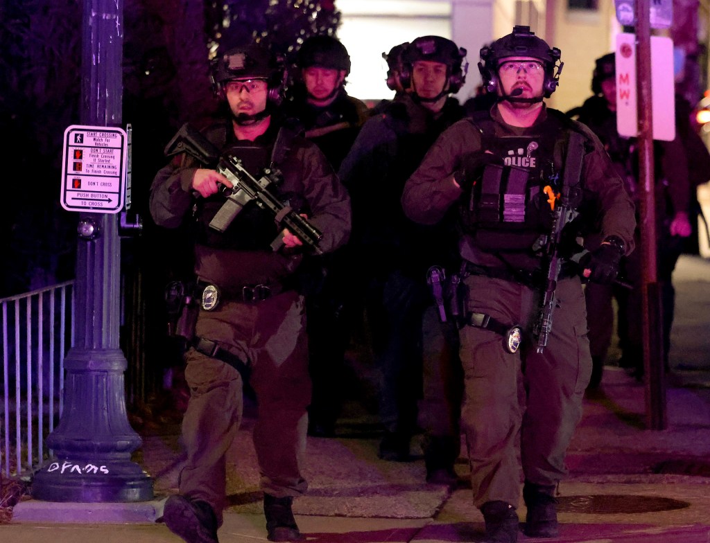 Police arrive at the scene in Providence, R.I., on Saturday, during the investigation of a shooting.