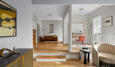 sunken living room with wood floor, view into dining area