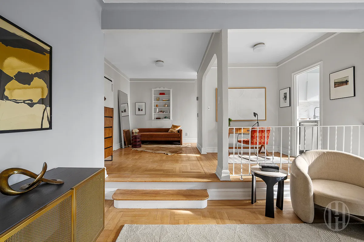 sunken living room with wood floor, view into dining area