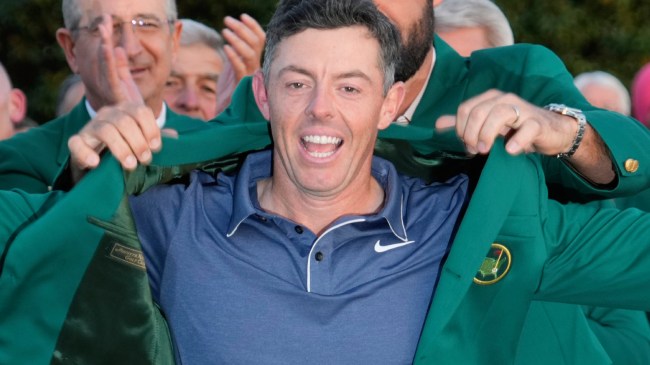 Rory McIlroy putting on green jacket after winning The Masters