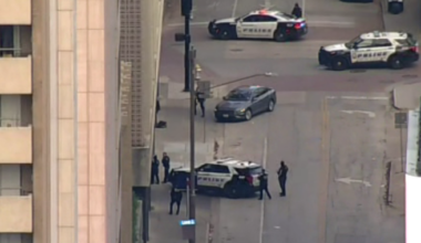 Dallas police in standoff with wanted felon barricaded in vehicle downtown
