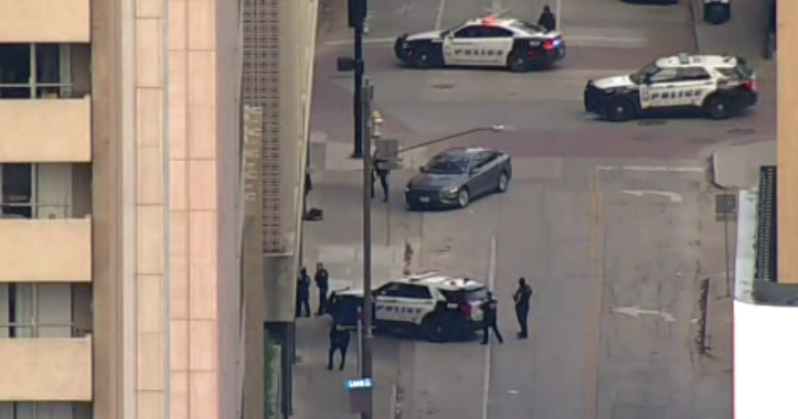 Dallas police in standoff with wanted felon barricaded in vehicle downtown