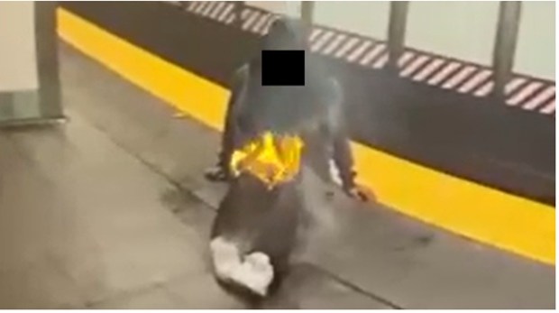 The victim is shown with his legs engulfed in flames at the 42nd St. - Times Square station. (US Attorney's Office) 