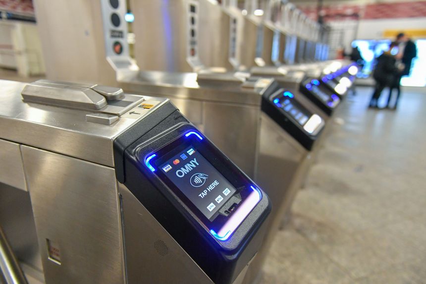 Monitors for the new Metropolitan Transportation (MTA) contactless fare payment system, known as the One Metro New York (OMNY), are seen on turnstiles at a subway station in New York.