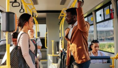 man and woman conversing on a bus.