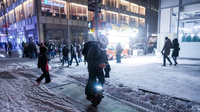 A person rides a unicycle through the snow in New York City. Pic: Reuters

